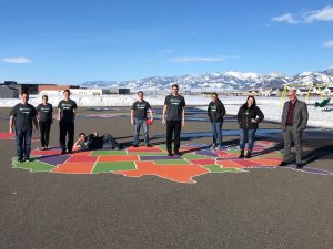 Employees standing on a map of the United States painted on the ground